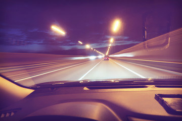 Sticker - Car dashboard and road with lights in motion against night sky with a vintage filter