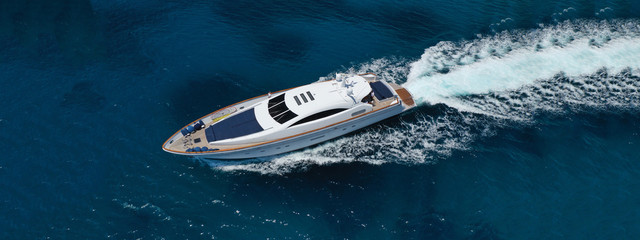 Wall Mural - Aerial drone top down photo of luxury yacht with wooden deck anchored in open ocean sea