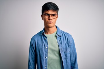 Sticker - Young handsome man wearing casual shirt and glasses over isolated white background skeptic and nervous, frowning upset because of problem. Negative person.