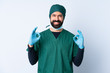 © luismolinero - Surgeon man in green uniform over isolated background showing ok sign with two hands