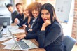 © Krakenimages.com - Group of business workers sitting in line with smile on face. Looking at the camera, young beautiful woman smiling at the office