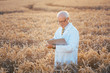 © Kzenon - Man doing research on genetically modified grain in wheat field