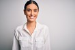 © Krakenimages.com - Young beautiful brunette woman wearing casual shirt over isolated white background with a happy and cool smile on face. Lucky person.