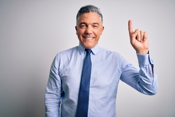 Poster - Middle age handsome grey-haired business man wearing elegant shirt and tie showing and pointing up with finger number one while smiling confident and happy.