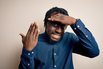 Sticker - Young african american man showing golden marriage ring on finger over white background stressed with hand on head, shocked with shame and surprise face, angry and frustrated. Fear and upset