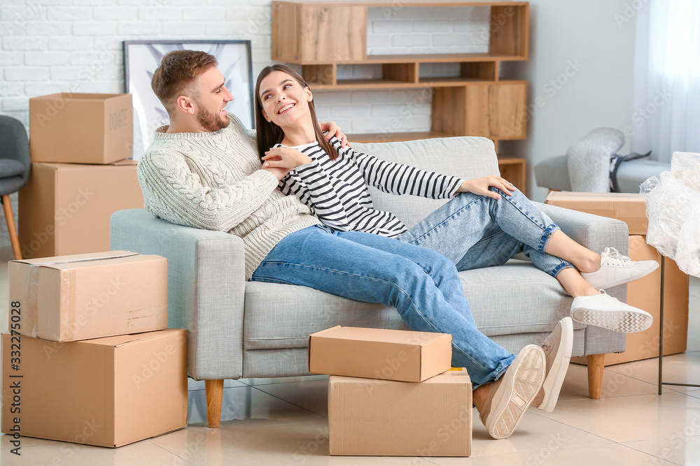 Young couple in their new flat on moving day