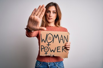 Young beautiful activist woman asking for change holding banner with united stand message with open hand doing stop sign with serious and confident expression, defense gesture