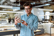 © Svitlana - Work and have fun. Young businessman posing in office