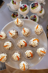 Wall Mural - Sweet table for birthday or wedding ceremony. Candy bar with a lot of different candies and sweet cakes. Selective focus. Party and holiday celebration concept