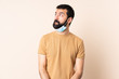 © luismolinero - Caucasian man with beard protecting from the coronavirus with a mask and gloves over isolated background having doubts while looking up