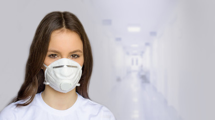 Woman in  medical mask with a blurry background. Concept of protection against viruses and airborne diseases spread via respiratory.