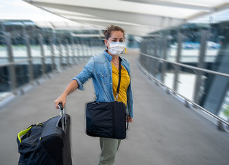 Wall Mural - Traveler with face mask affected by coronavirus travel ban and COVID-19 pandemic flight restrictions