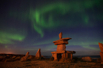 Wall Mural - northern lights in churchill manitoba with an iconic inukshuk in the foreground