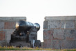 a historic naval cannon points towards the hudson bay from a stone fort