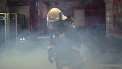 Wall Mural - female firefighter portrait wearing full equipment, oxygen mask, and emergency rescue equipment, hard tool, smoke and fire trucks in the background.