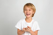 © New Africa - Happy little boy on light grey background