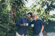© chokniti - Old father and son, Morning coffee in a garden