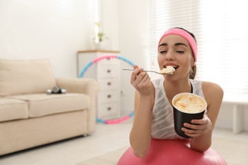 Lazy young woman eating ice cream at home. Space for text