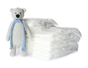 Wall Mural - disposable diapers and toy bear on white background