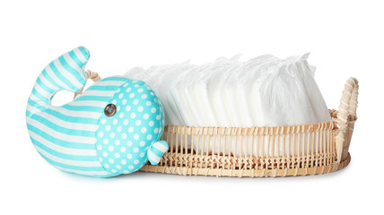 Wall Mural - wicker tray with disposable diapers and toy on white background