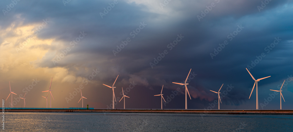 Offshore wind farm at beautiful, dramatic sunset - obrazy, fototapety, plakaty 