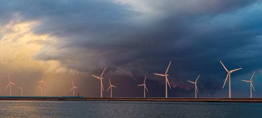 Wall Mural - offshore wind farm at beautiful, dramatic sunset