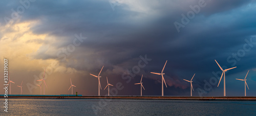 Fotografía Offshore wind farm at beautiful, dramatic sunset