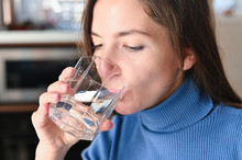 Drink Plenty Of Water From The Virus, Covid-19 Pandemic Coronavirus. Girl Drinks Water From A Glass
