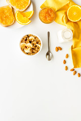 Wall Mural - Vegetarian breakfast with granola and fruits on white background top-down frame copy space