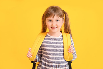 Poster - Cute little schoolgirl on color background