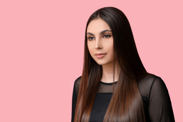 Young woman with beautiful straight hair on color background