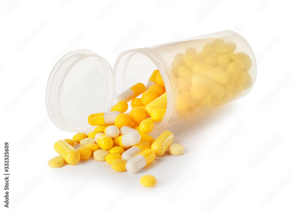 Bottle with different pills on white background