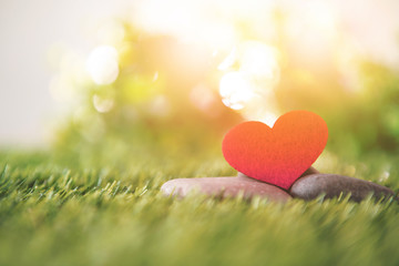 close up red heart shape on green fresh grass , good relax and love romance feeling symbol , valentines day background