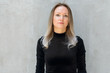 © Ranta Images - Beautiful blonde businesswoman against concrete wall outdoors