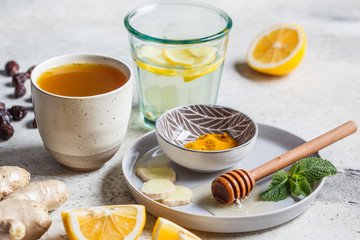 Warm drinks with turmeric, ginger, honey, mint and lemon. Beverage for boosting immunity concept.