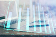 © peshkova - Forex graph hologram on table with computer background. Double exposure. Concept of financial markets.