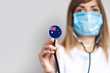 female doctor in a medical mask holds a stethoscope on a light background. Added flag of Australia. Concept medicine, level of medicine, virus, epidemic