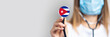 female doctor in a medical mask holds a stethoscope on a light background. Added flag of Cuba. Concept medicine, level of medicine, virus, epidemic. Baner