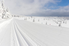 Groomed track for cross country skiing mountains blue sky