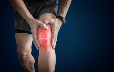 Joint pain, Arthritis and tendon problems. a man touching nee at pain point