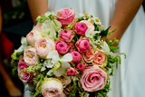Fototapeta Kwiaty - A beautiful bouquet of the bride in her hands.