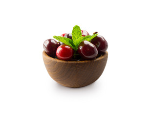 Wall Mural - Red cherries in bowl isolated on white background. Ripe cherries and mint leaves close-up. Sweet and juicy berry with copy space for text. Various fresh summer fruits isolated on white.