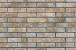Wall of brown stone decorative facing brick texture, background
