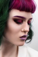 Beautiful woman with purple green professional colored hair