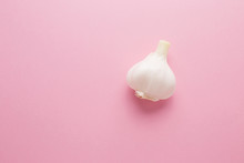 Garlic On A Pink Background Close-up. Prevention Of Virus Diseases.