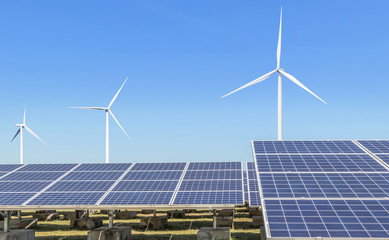 Wall Mural - solar cells or solar panels or photovoltaic cells with wind turbines generating electricity alternat