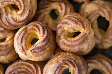 Sticker - Italian pastry - baked  puffs made from choux pastry, or bignè. Top view.