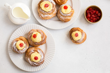 Poster - Italian pastry - zeppole di San Giuseppe - baked cream puffs made from choux pastry, filled and decorated with custard cream and cherry. It is eaten to celebrate Saint Joseph's Day.