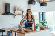 © undrey - Portrait of a young athletic woman at home in the kitchen