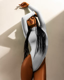 African woman stylish portrait in underwear on yellow or white background. Girl posing with beautiful body